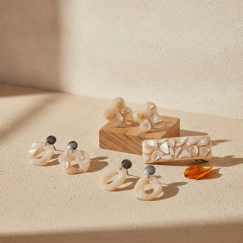 Resin and shell accessories on a pale surface